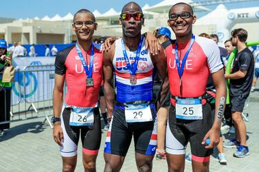 Abu Dhabi, United Arab Emirates, March 8, 2019. Special Olympics ITU Traiathlon at the YAS Marina Circuit. -- (L-R) Micah Hambleton (UAE), Trent Hamton (USA) and Jonah Hambleton (UAE) after the triathlon. Besa/The National Section: NA Reporter: Haneen Dajani