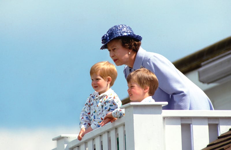 The queen with Prince William and Prince Harry watch a polo match in Windsor in 1987. Getty