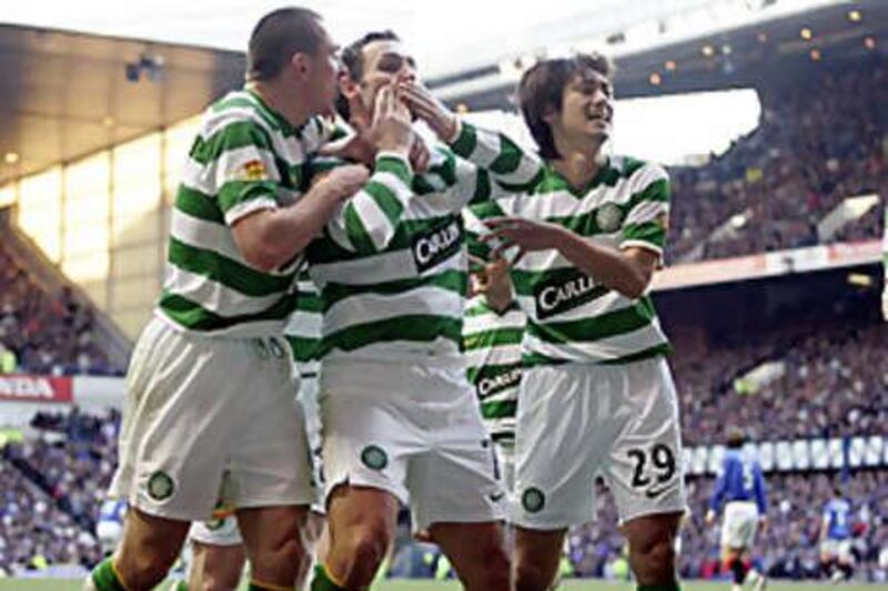The Celtic hero Scott MCDonald, centre, celebrates his winner with Scott Brown, left, and Koki Mizuno.
