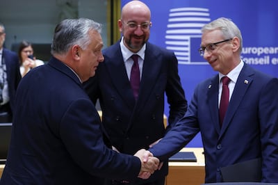European Council President Charles Michel looks on as Hungarian Prime Minister Viktor Orban, left, shakes hands with Bulgarian Prime Minister Nikolai Denkov, right, at an EU leaders' summit in Brussels. Reuters