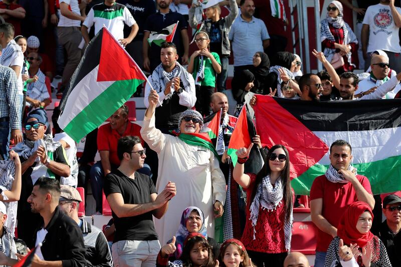 Palestine supporters cheer ahead of match. AFP