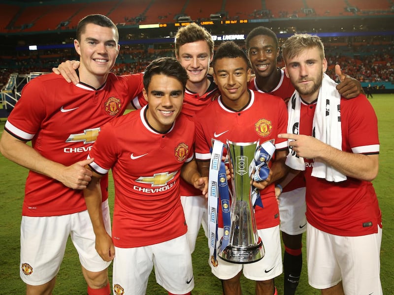 MIAMI GARDENS, FL - AUGUST 04:  Michael Keane, Reece James, Will Keane, Tyler Blackett,  Luke Shaw and Jesse Lingard of Manchester United pose with the International Champions Cup trophy after the pre-season friendly match between Manchester United and Liverpool at Sun Life Stadium on August 4, 2014 in Miami Gardens, Florida.  (Photo by John Peters/Manchester United via Getty Images)