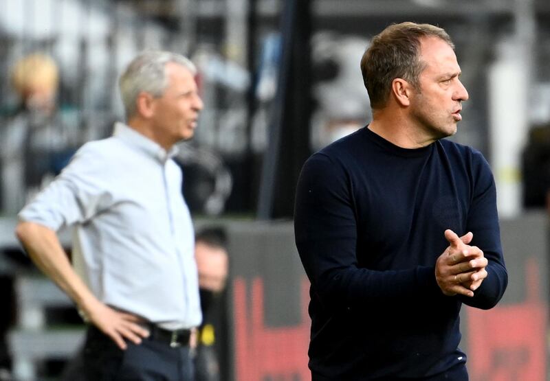 Bayern Munich' manager Hansi Flick, right, and Borussia Dortmund counterpart Lucien Favre. AFP