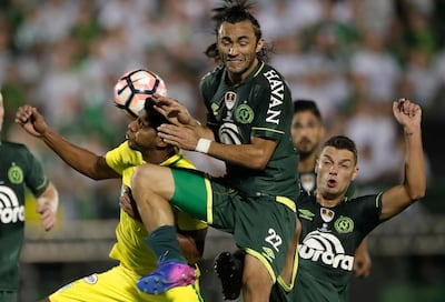 In this Tuesday, April 4, 2017 photo, Luis Carlos Ruiz of Colombia's Atletico Nacional, left, fights for the ball with Apodi of Brazil's Chapecoense at a Recopa Sudamericana first leg final soccer match in Chapeco, Brazil. (AP Photo/Andre Penner)