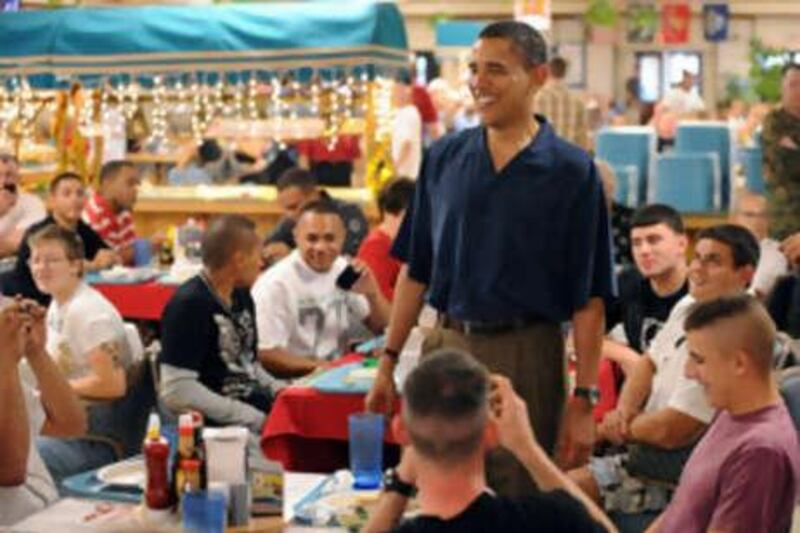 Barack Obama talks to US Marines while they have Christmas dinner.