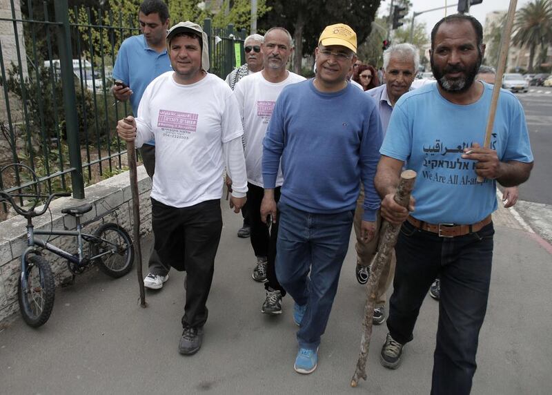 The head of Israel's Arab parliamentary bloc Ayman Odeh, left, walks alongside supporters as they arrive in Jerusalem on March 29, 2015, after a four-days march from the Bedouin village of Wadi Al Naam, near the city of Beersheba, to support Bedouin Arabs. Ahmad Gharabli/AFP Photo