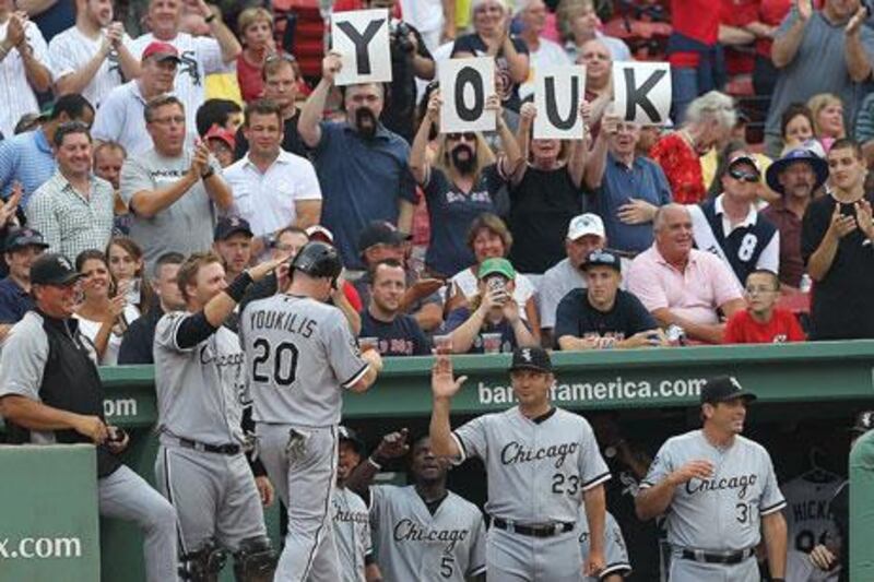 Kevin Youkilis celebrates with Chicago White Sox teammates after scoring a run against former side Boston