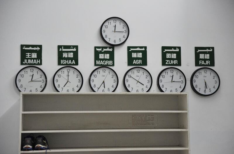Clocks showing the daily prayer schedule for Muslims at a mosque in Taipei. Mandy CHENG / AFP