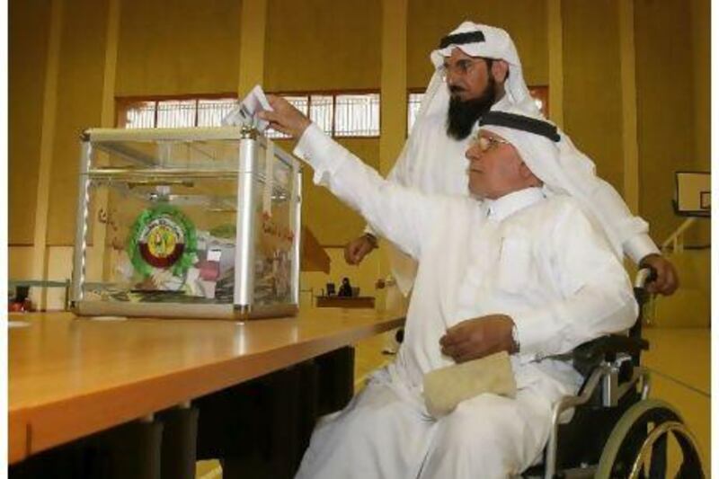 A Qatari casts his vote during the municipal elections at a polling station in Doha yesterday.