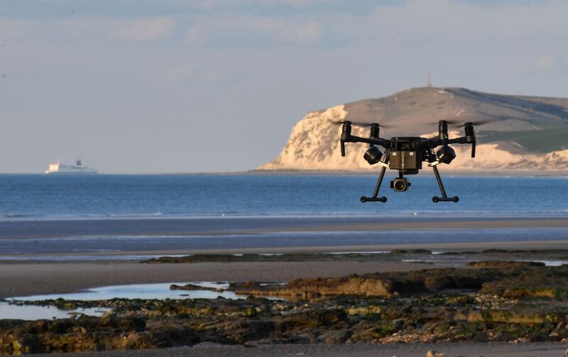 A cross Channel ferry sail in the background as a drone used by the French border police takes off during a patrol of the beaches at Tardinghen near the northern port city of Calais on April 4, 2019. 
 Since the end of October 2018, the French and British authorities have been facing an upsurge in illegal Channel crossings from France to Britain by migrants and refugees. A plan by the French government implemented at the start of the year which stepped-up police patrols around ports, as well as surveillance of beaches where dinghies have been launched from, has seen a drop in crossing attempts according to the prefecture of Pas-de-Calais on April 4, 2019.  / AFP / Denis Charlet
