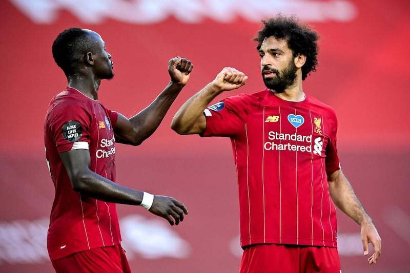 epa08507154 Liverpool's Mohamed Salah (R) celebrates with his teammate Sadio Mane (L) after scoring the 2-0 lead during the English Premier League match between Liverpool FC and Crystal Palace in Liverpool, Britain, 24 June 2020.  EPA/Paul Ellis/NMC/Pool EDITORIAL USE ONLY. No use with unauthorized audio, video, data, fixture lists, club/league logos or 'live' services. Online in-match use limited to 120 images, no video emulation. No use in betting, games or single club/league/player publications.