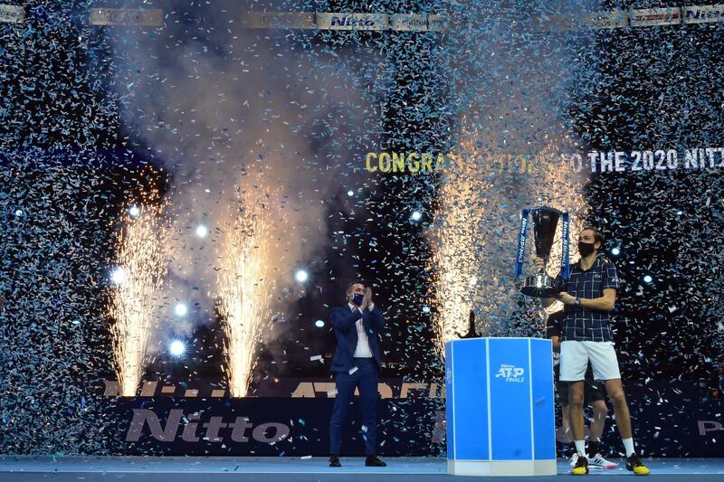 Daniil Medvedev poses with the winner's trophy after his win over Dominic Thiem in the final match of the ATP Finals. AFP