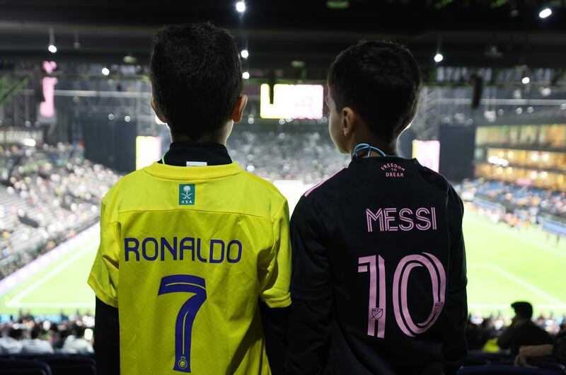 Fans sporting the jersey's Al Nassr's Cristiano Ronaldo and Inter Miami's Lionel Messi. Getty
