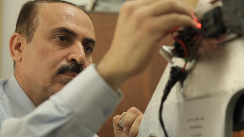 Gazan engineer Ismail Abu Skheila working on his ventilator prototype.