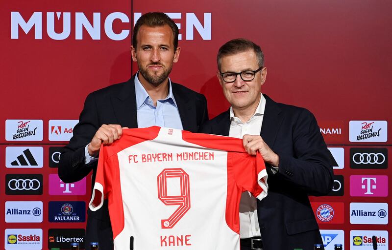 Bayern Munich new boy Harry Kane alongside chief executive Jan-Christian Dreesen after the striker's unveiling on August 13, 2023.  AFP