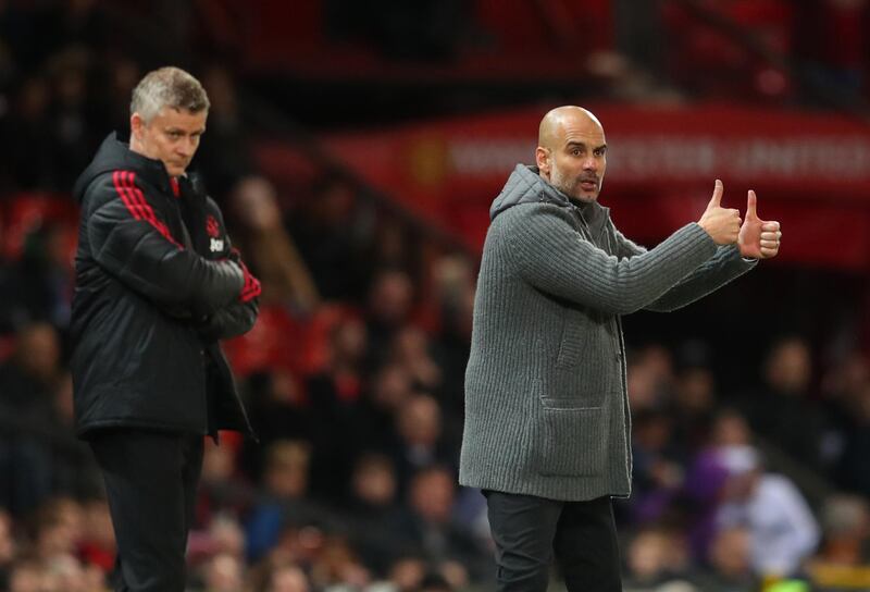 A thumbs up from City manager Pep Guardiola as United counterpart Ole Gunnar Solskjaer watches on. Catherine Ivill / Getty Images