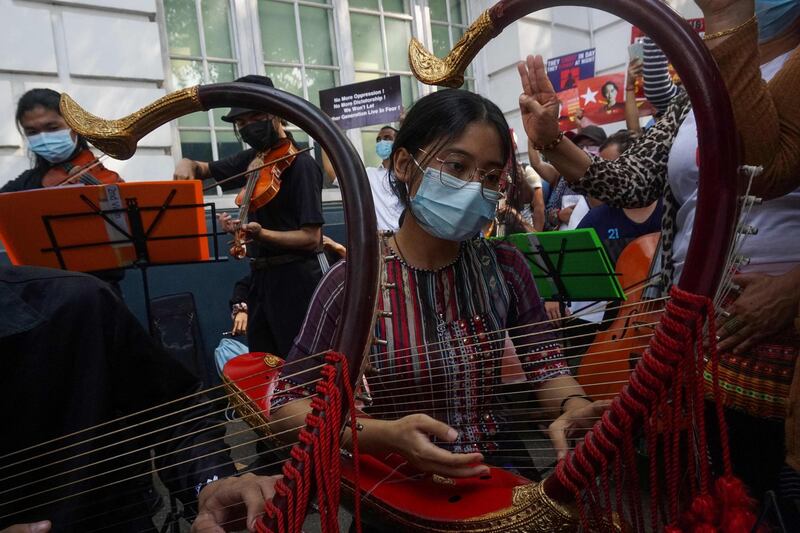 Musicians perform outside the British embassy during a demonstration against the military coup in Yangon. AFP