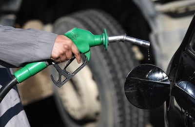 A customer fills his car petrol tank at a Shell station in London. EPA