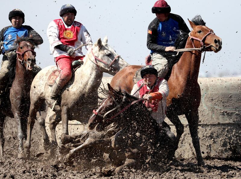 Kyrgyz horsemen play the traditional sport of kok-boru (goat dragging) in the village of Sokuluk, Kyrgyzstan. EPA