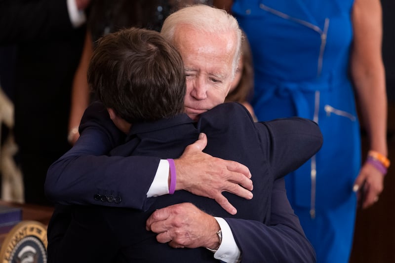 The president hugs his grandson Robert Biden, the son of the late Beau Biden, during the ceremony. EPA