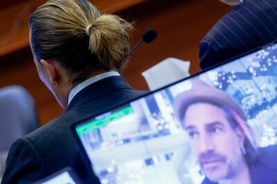 Johnny Depp in court as a pre-recorded deposition testimony of Christian Carino is played on a screen during the Depp versus Heard defamation trial. EPA