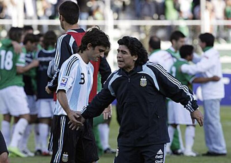 Maradona tires to console Emiliano Papa after their 6-1 defeat to Bolivia in La Paz on April 1.