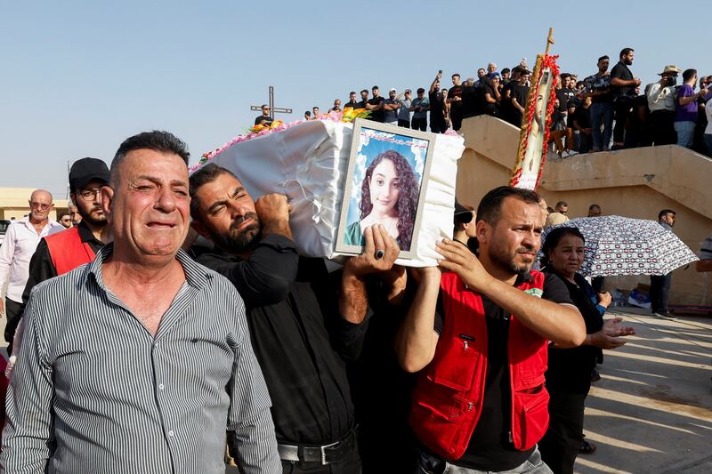 Mourners carry a coffin. Reuters