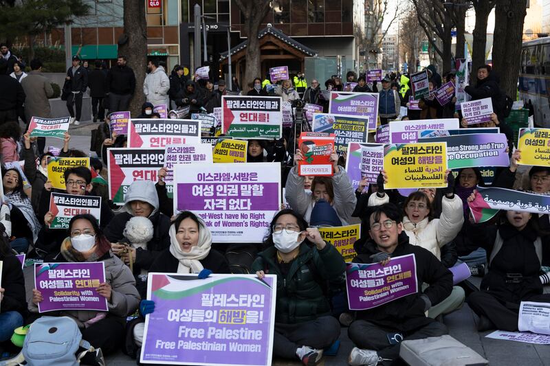 Supporters of Palestine shout slogans during a rally in celebration of International Women's Day in Seoul. EPA