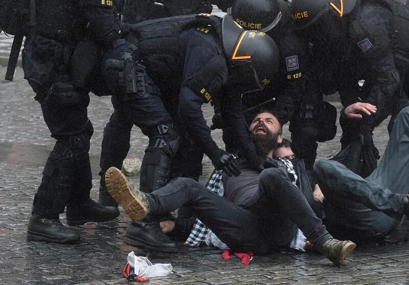 Riot police move in against protestors at the Old Town Square as hundreds of demonstrators, mostly football supporters, protest against the Czech government's new measures to slow the spread of the Covid-19 coronavirus in Prague.  AFP