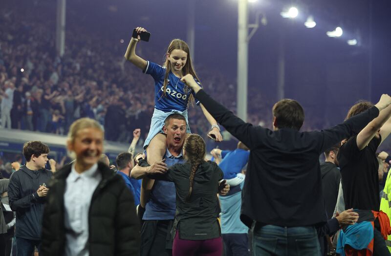 Everton fans invade the pitch as they celebrate. Reuters