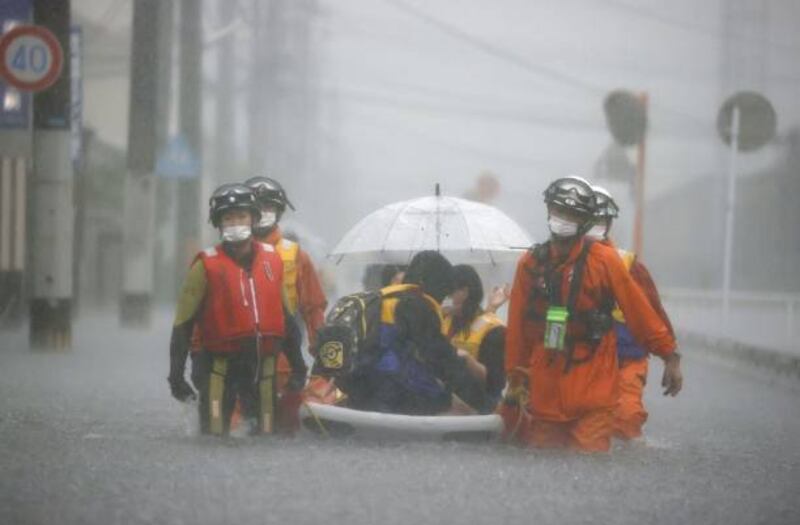 Workers rescue stranded citizens in the Fukuoka Prefecture city of Kurume, south-western Japan, during heavy flooding on August 14. Kyodo News via Getty Images
