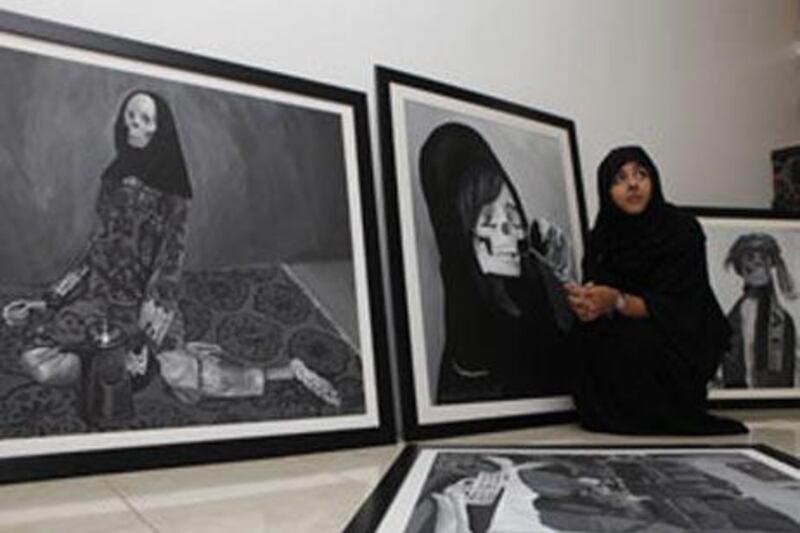 Maisoon al Saleh, 22, at home with her works. "We all end up looking like this," she said.