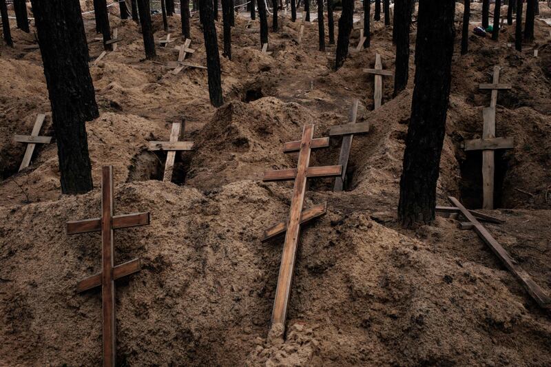 A mass grave site uncovered by Ukrainian authorities after Russia's occupation in Izium. UN investigators accused Russia last week of committing war crimes in Ukraine. AFP