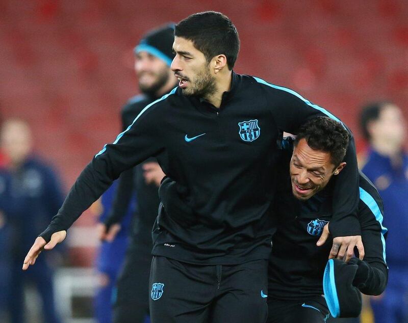 LONDON, ENGLAND - FEBRUARY 22:  Luis Suarez (L) jokes with team mate Adriano during a FC Barcelona training session ahead of their UEFA Champions League round of 16 first leg match against Arsenal at the Emirates Stadium on February 22, 2016 in London, United Kingdom.  (Photo by Matthew Lewis/Getty Images)