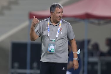 Wahda's coach Henk ten Cate speaks to his technical staff during the AFC Champions League Round of 16 football match between UAE's Sharjah and UAE's Al-Wahda on September 14, 2021, at the Sharjah Football Stadium in the Emirati city.  (Photo by -  /  AFP)