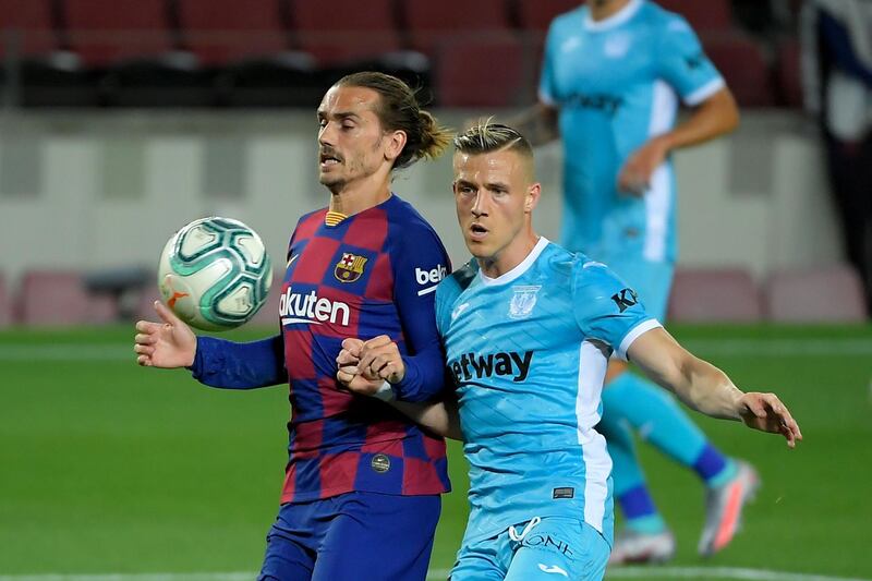 Barca attacker Antoine Griezmann is challenged by Leganes defender Rodrigo Tarin. AFP