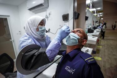 A swab test is carried out at the new screening centre in Mussaffah. Victor Besa/The National     