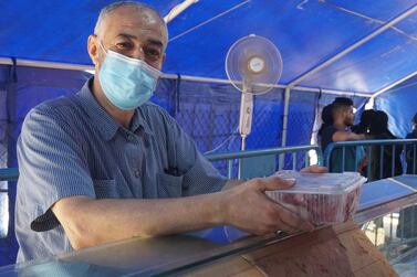 Ali Chahrour, a worker at a local mosque in Nabatieh, collects free meat from an aid distribution centre in the southern Lebanese city. Sunniva Rose / The National