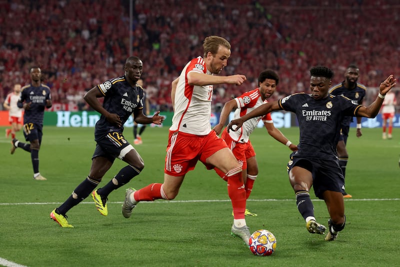 Bayern Munich striker Harry Kane is challenged by Real Madrid midfielder Aurelien Tchouameni during the Uefa Champions League semi-final first leg match at Allianz Arena on April 30, 2024 in Munich, Germany. Getty Images