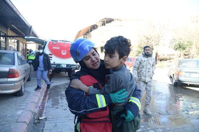 Hamda Al Hammadi, an advanced paramedic from the UAE, carries a rescued Syrian child to safety. Photo: Wam