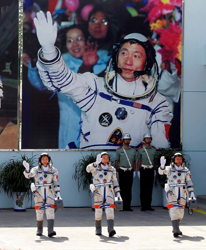 A photo from 2012 showing Chinese astronauts from Liu Yang, Jing Haipeng and Liu Wang as they wave before a giant portrait of China's first astronaut Yang Liwei, as they depart for the Shenzhou 9 spacecraft rocket launch pad at the Jiuquan Satellite Launch Center in Jiuquan, China. File photo / AP Photo.
