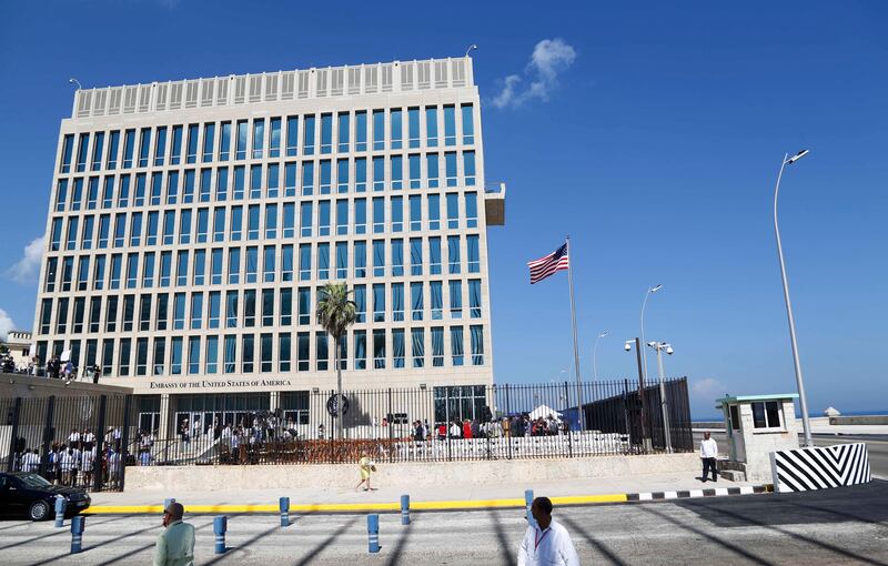 In this photo taken Aug. 14, 2015, a U.S. flag flies at the U.S. embassy in Havana, Cuba. At least 16 Americans associated with the U.S. Embassy in Havana suffered symptoms from attacks on their health in Cuba that have still not been explained, the United States said Thursday, Aug. 24, 2017.  (AP Photo/Desmond Boylan)