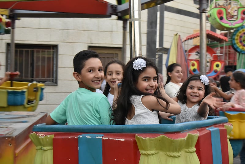 Children celebrate Eid Al Adha at an amusement park in Damascus, Syria.