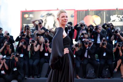 Cate Blanchett at the closing ceremony wearing an asymmetric dress with a cape. Getty 