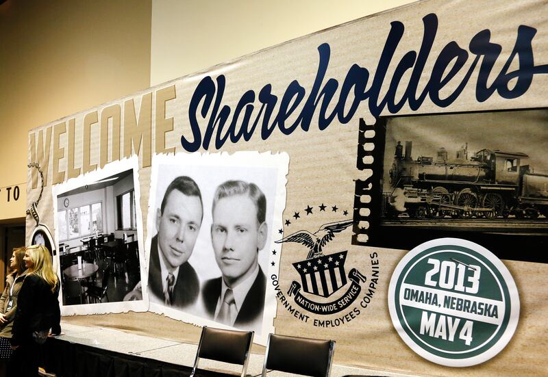 A Berkshire Hathaway board displays a vintage picture of Mr Buffett, left, and Munger, at an annual general meeting in Omaha in May 2013. Reuters