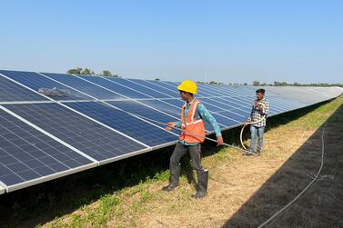 Workers clean panels at a solar park in Modhera, India's first round-the-clock solar-powered village, in the western state of Gujarat, India, October 19, 2022.  REUTERS / Sunil Kataria