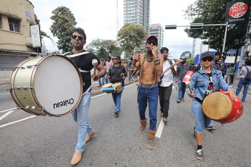 University students shout slogans and bang the drums. EPA