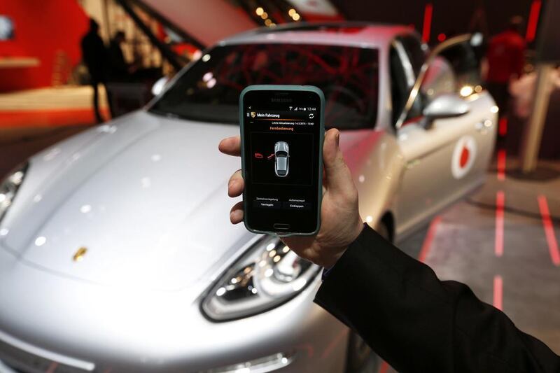 An engineer shows an app on his smartphone providing control over several functions of a Porsche connected car. The UK government has issued guidelines to try to ensure such cars cannot be hacked. Morris Mac Matzen / Reuters