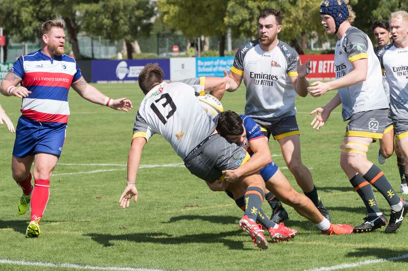 Dubai Hurricanes (grey/white shirts) take on Jebel Ali Dragons at The Sevens Stadium in Dubai. Ruel Pableo for The National