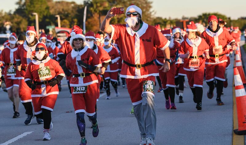 More than 800 runners dressed as Santa Claus braved near-freezing temperatures to participate in the Run Run Santa 1 Mile on Christmas Eve. Florida Today / AP